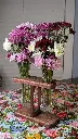 Two of a Kind Sabrina Red Mahogany with fresh flowers.webp